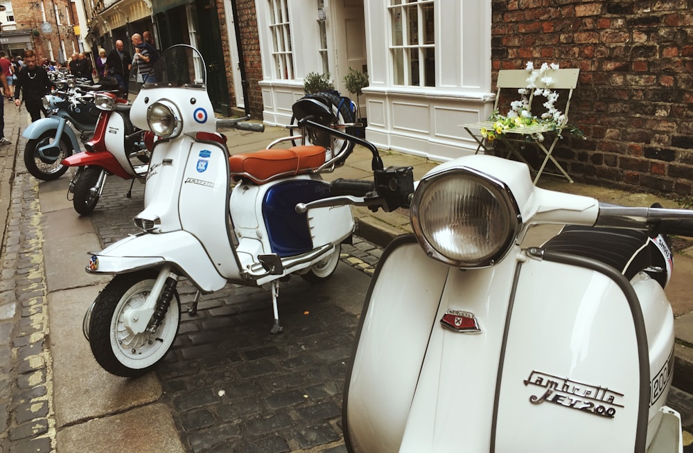 white and orange motor scooter