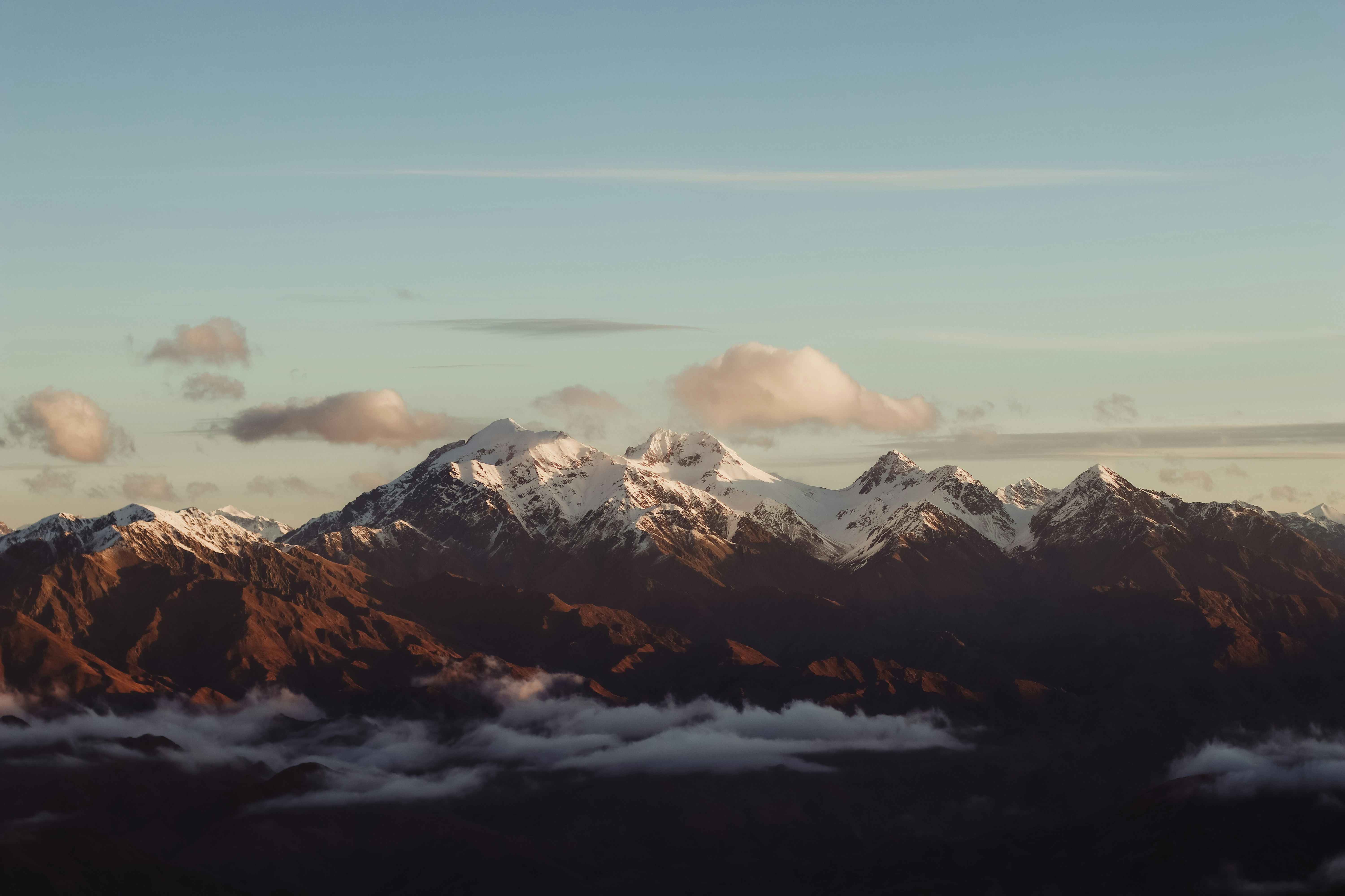 snow covered mountain under cloudy sky during daytime