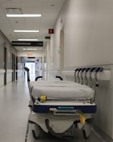 Hospital stretcher with wheels in a corridor.