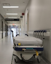 A solemn, respectful image of a quiet, empty hospital corridor symbolizing the serious nature of the content.