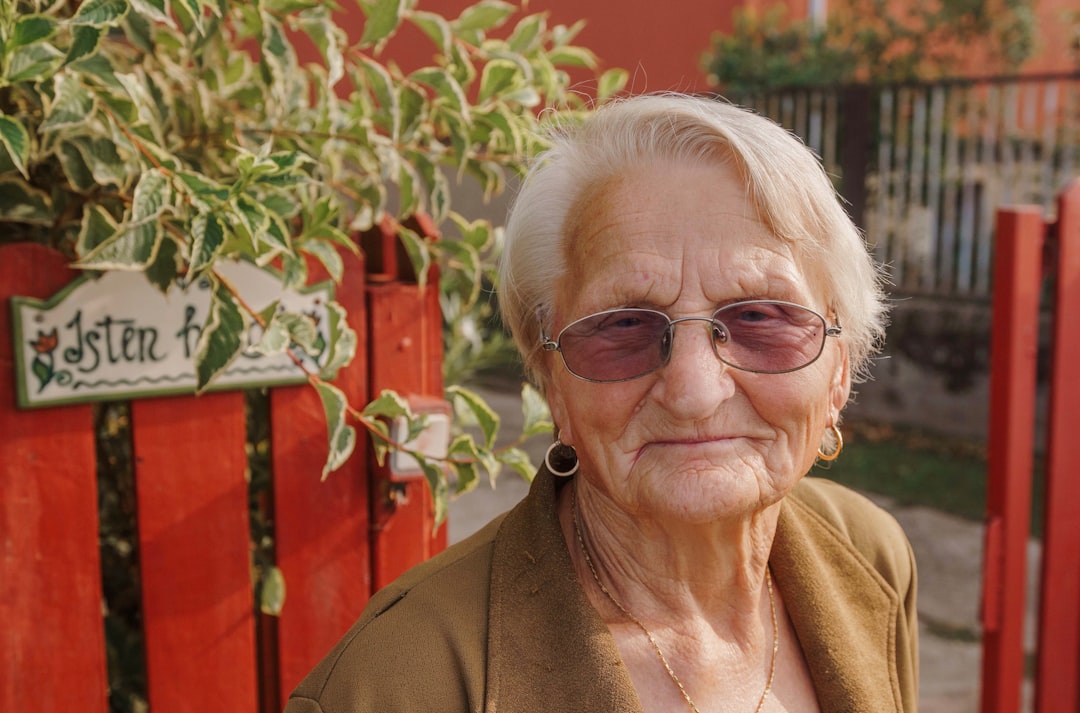 woman in brown framed eyeglasses and brown coat