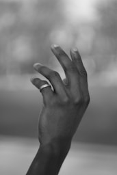 grayscale photo of persons left hand