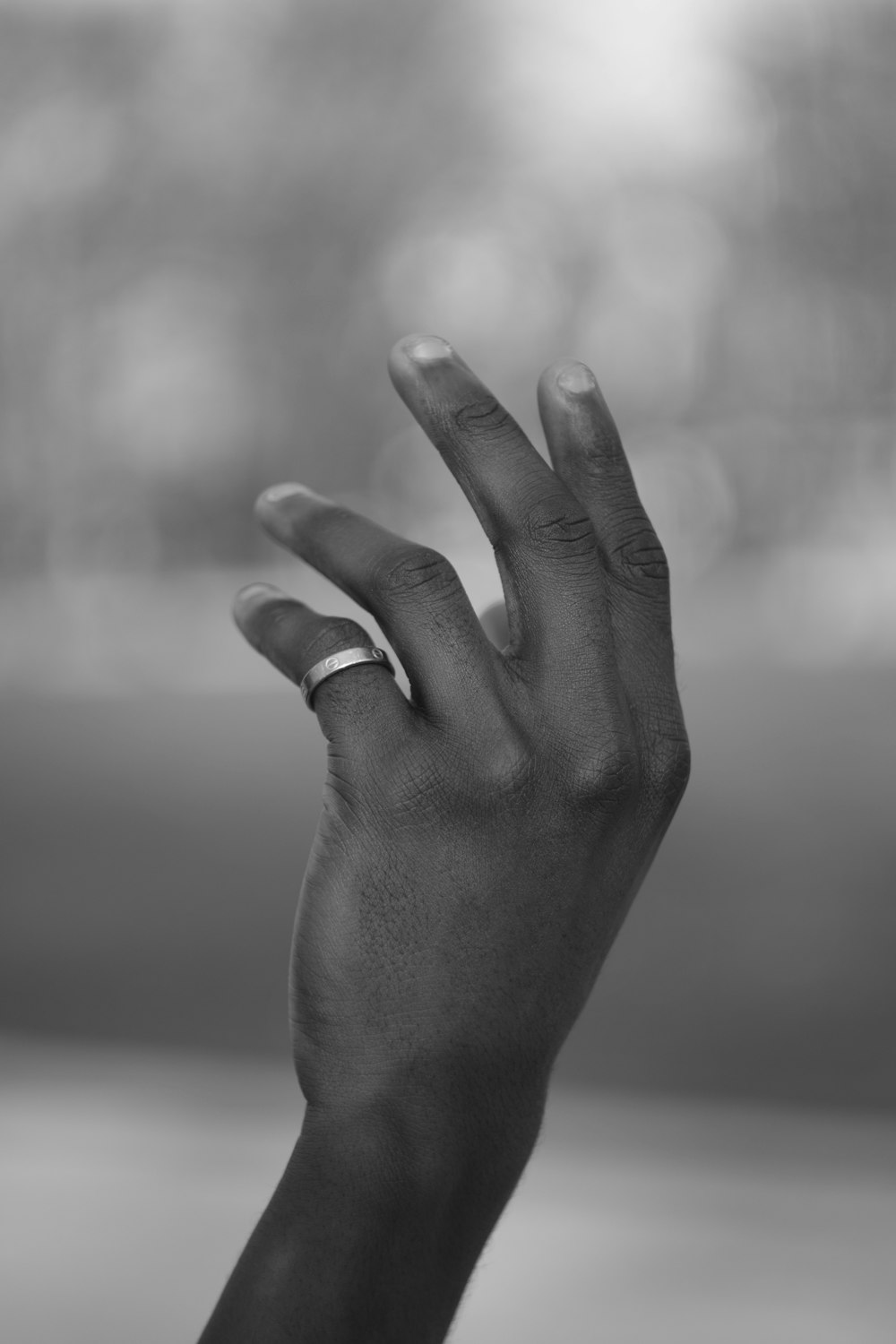 grayscale photo of persons left hand