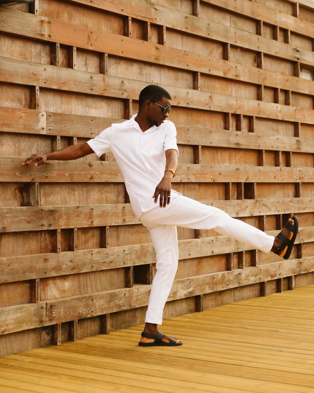 man in white shirt and pants wearing black shoes