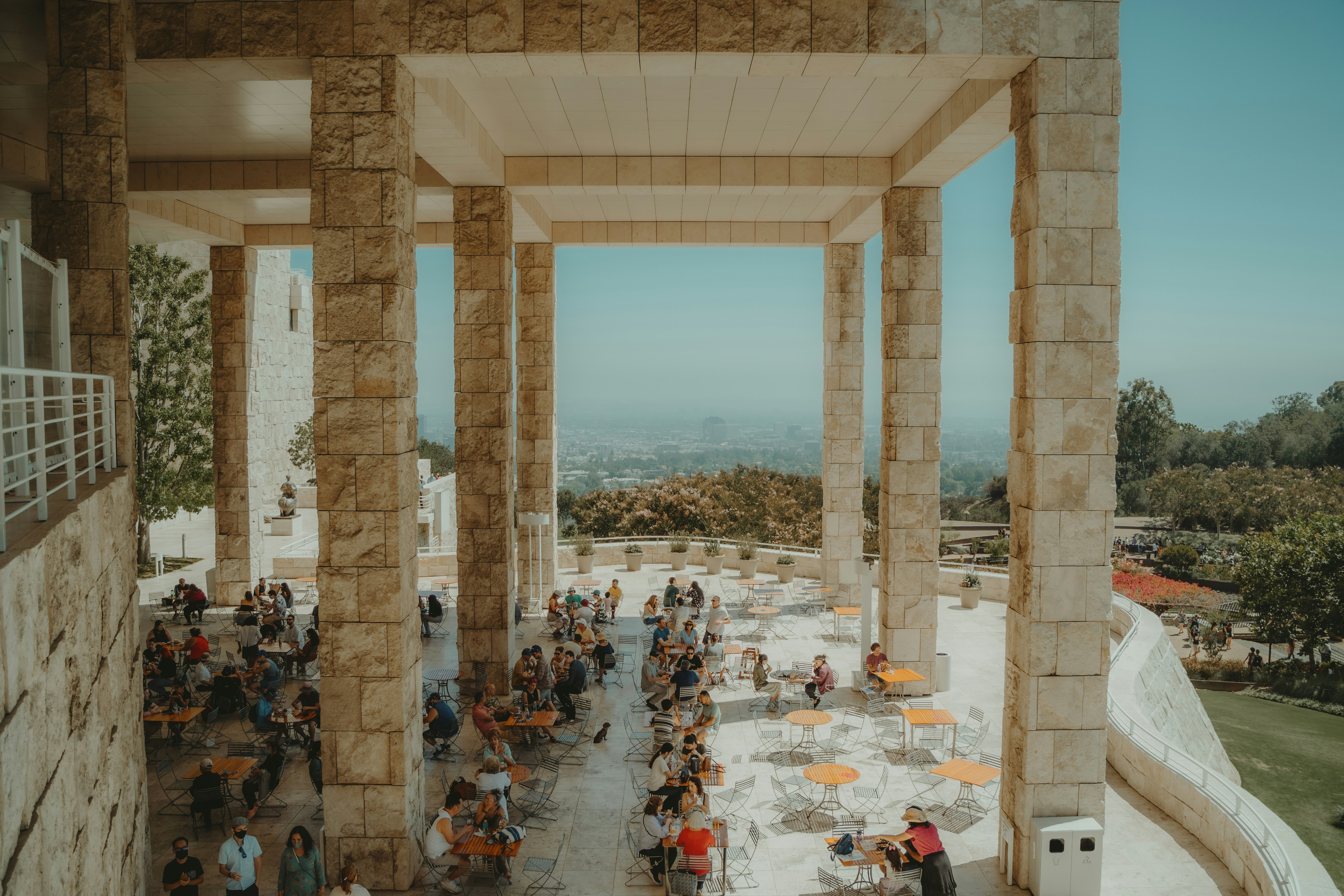 people sitting on chairs near table and body of water during daytime