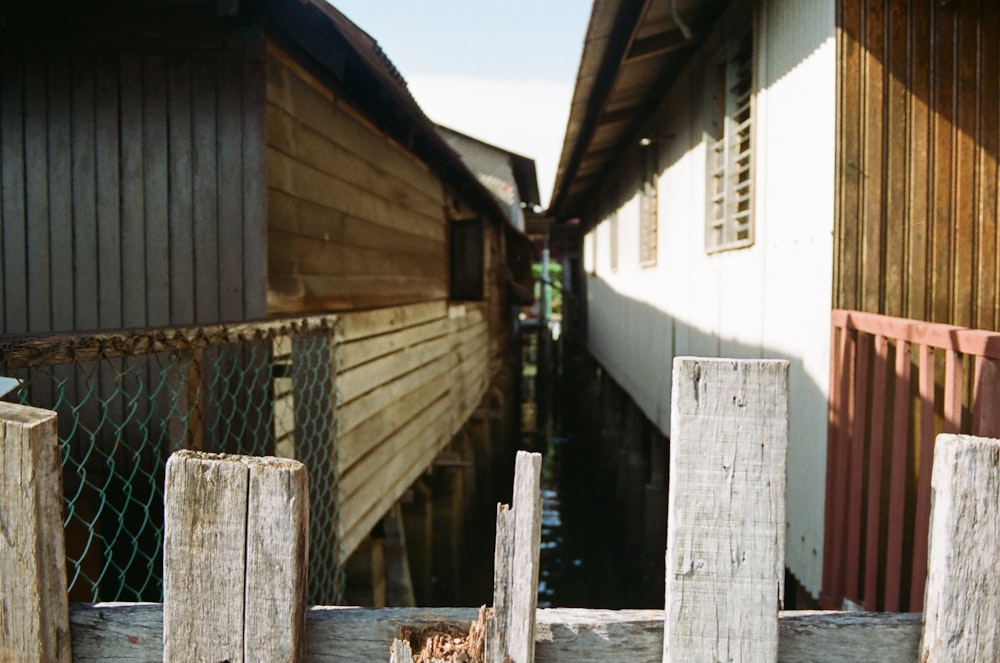 brown wooden fence on white concrete building during daytime