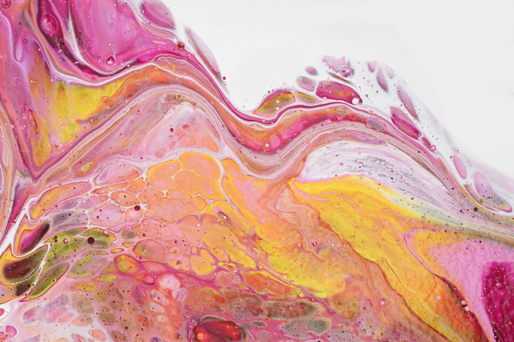 a close up of a colorful liquid painting