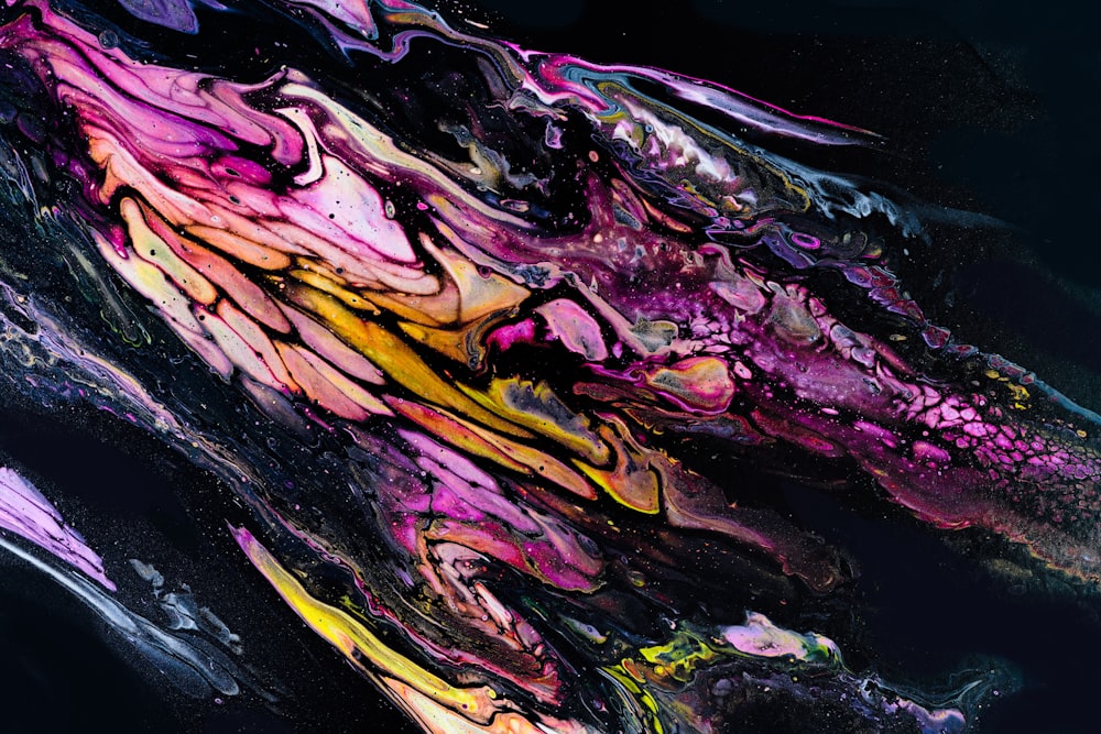 a close up of an abstract painting with a black background