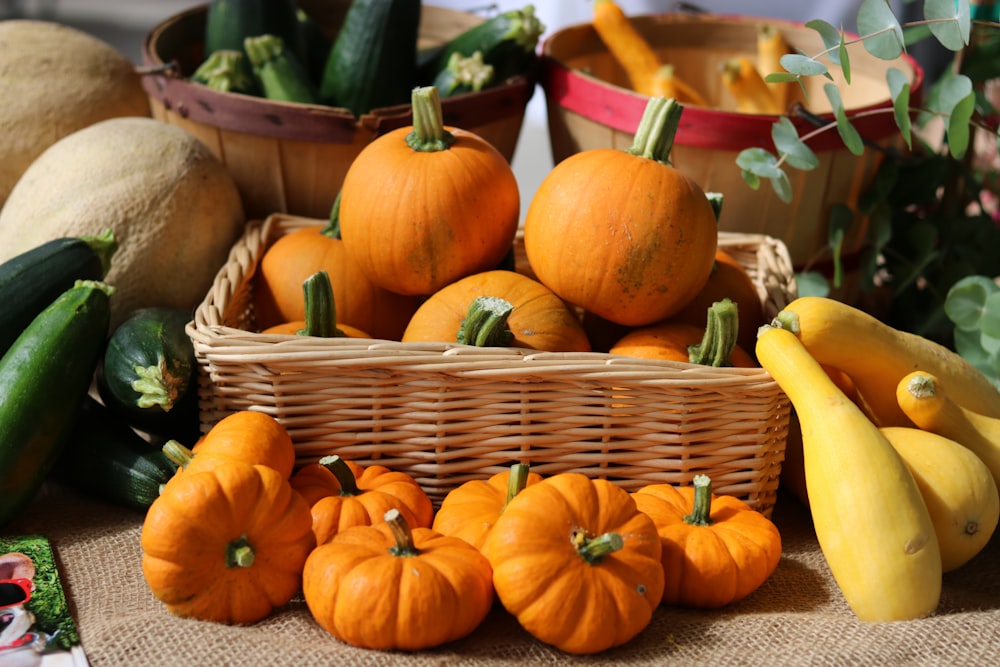 orange pumpkins on brown woven basket