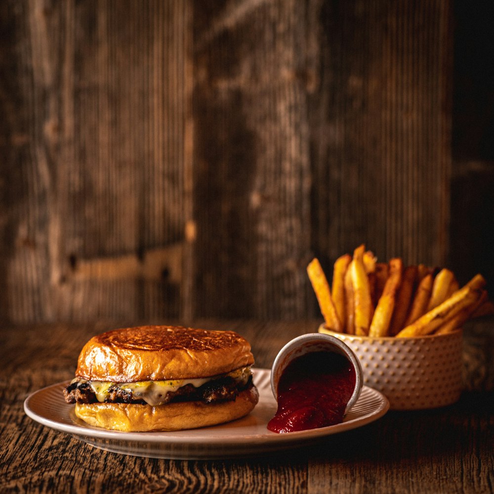 burger and fries on white ceramic plate