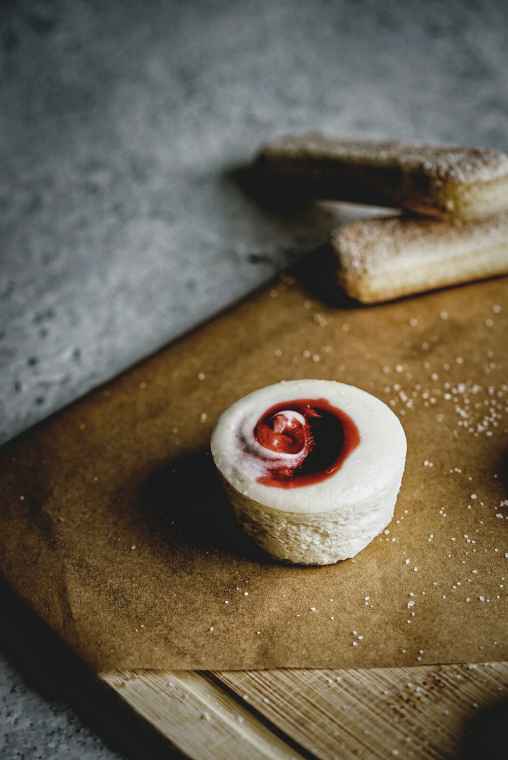 white and red round ornament on brown wooden table