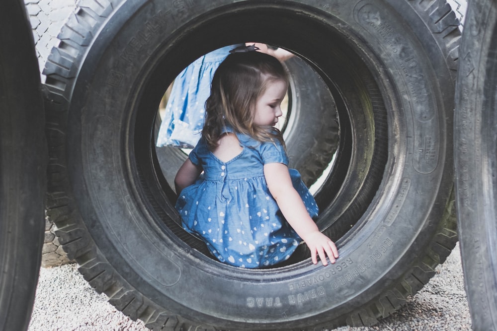 girl in blue dress in black tire