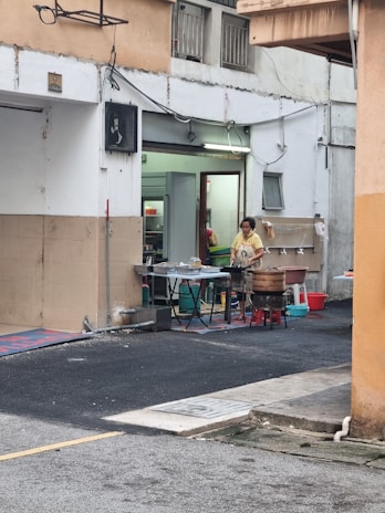 Technician setting up a bait station outside a commercial building.