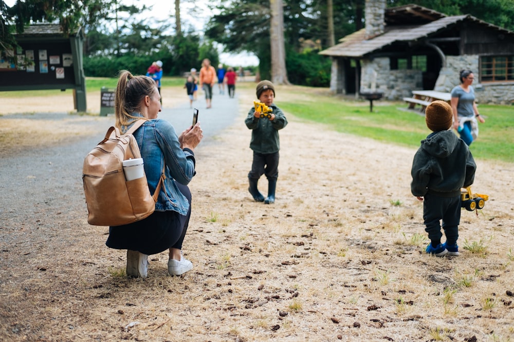 girl in black jacket carrying brown leather backpack