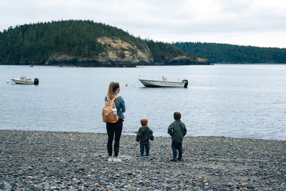 2 women and 2 men standing on shore during daytime