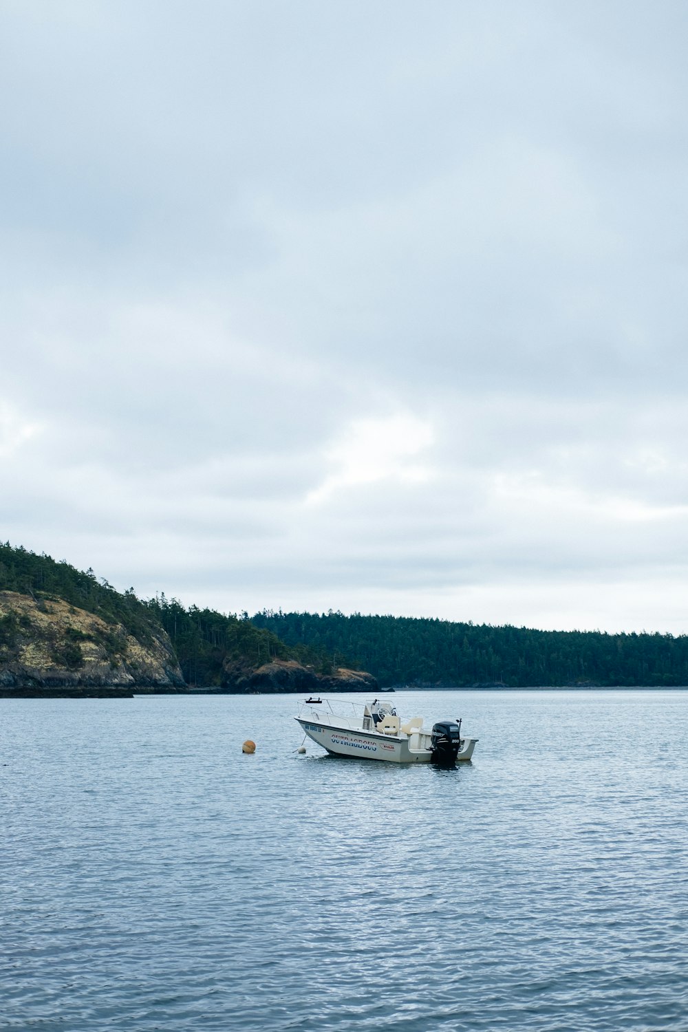 white boat on body of water during daytime