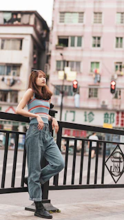 woman in blue denim jeans sitting on black wooden bench