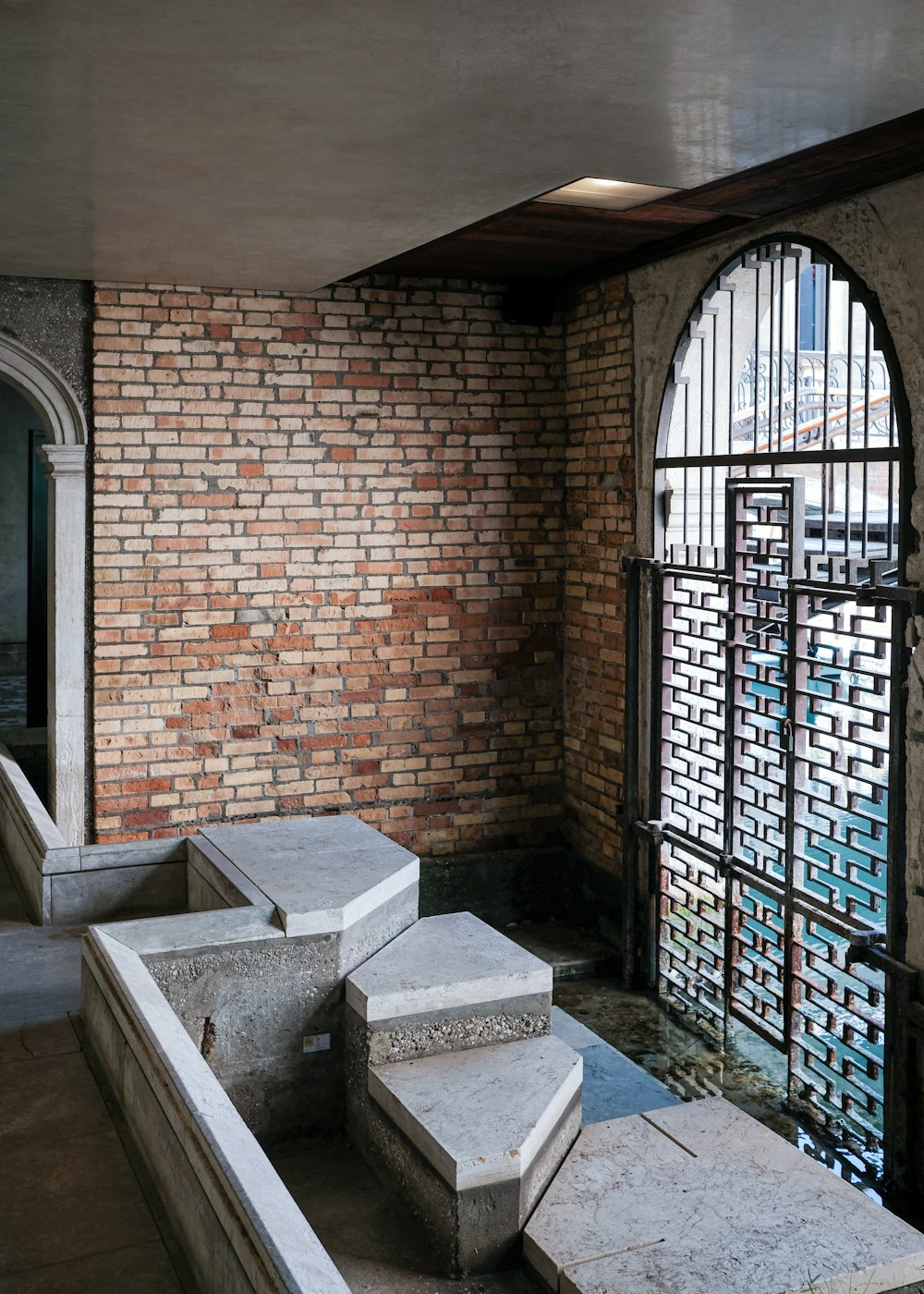 brown brick building with black metal gate