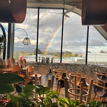 A cozy corner inside Pride Haven with colorful pride flags and warm lighting.