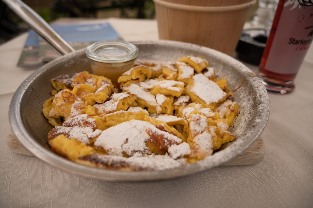 brown and white food on stainless steel round tray