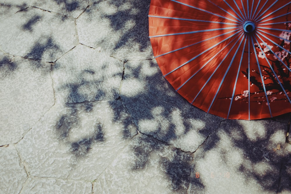 orange hand fan on white and black textile