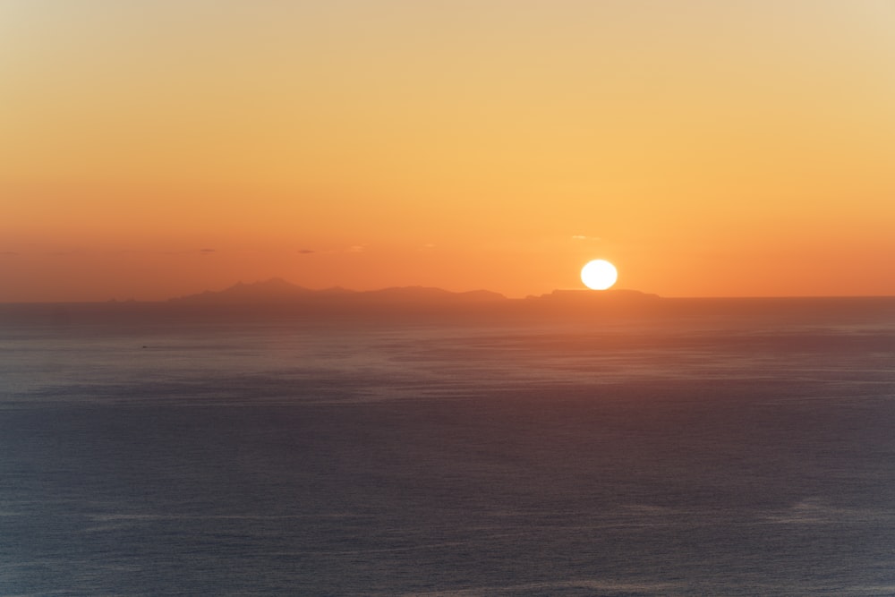 body of water during sunset