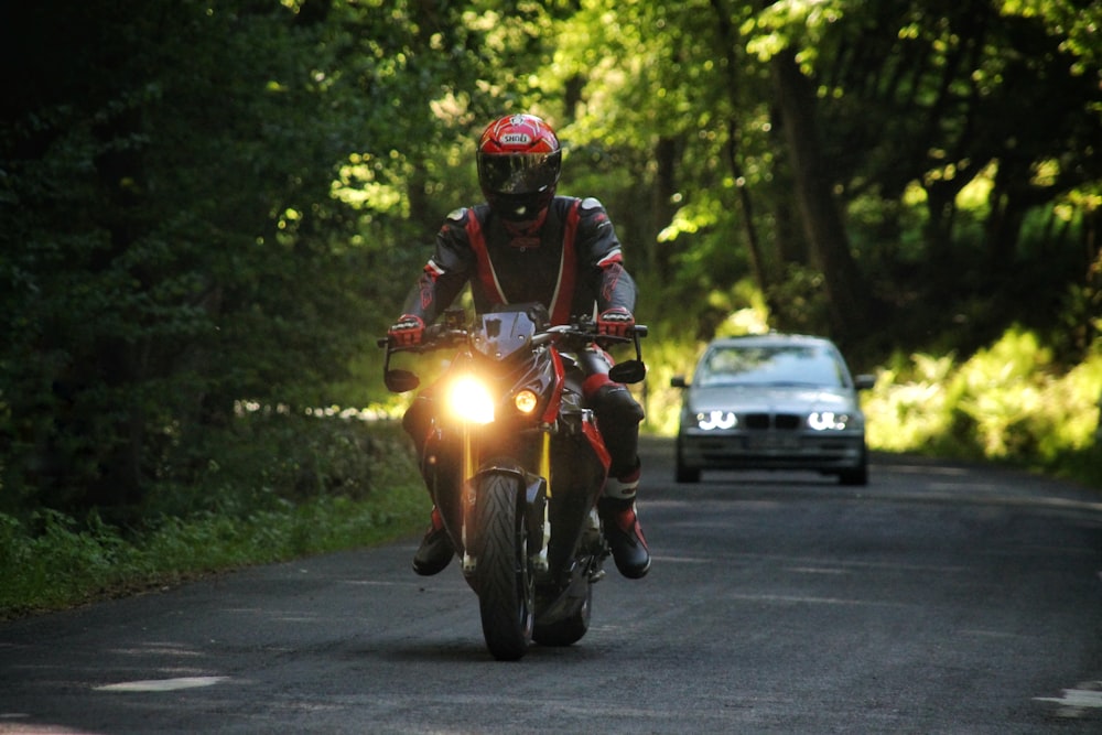 man in green and black motorcycle suit riding yellow motorcycle on road during daytime