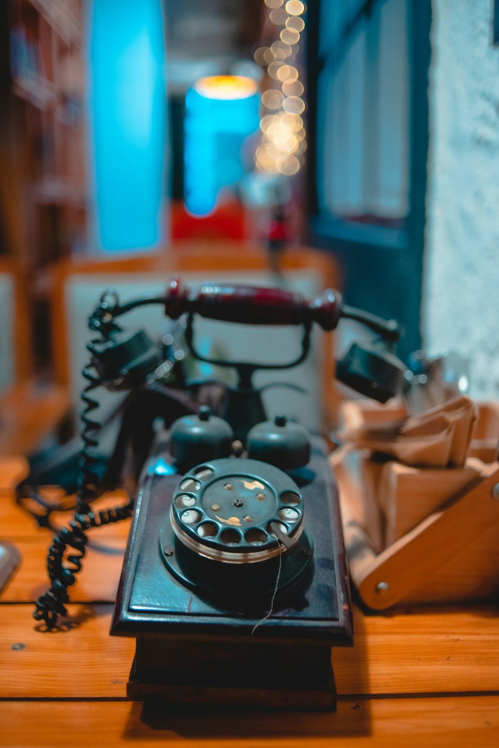 black rotary phone on brown wooden table