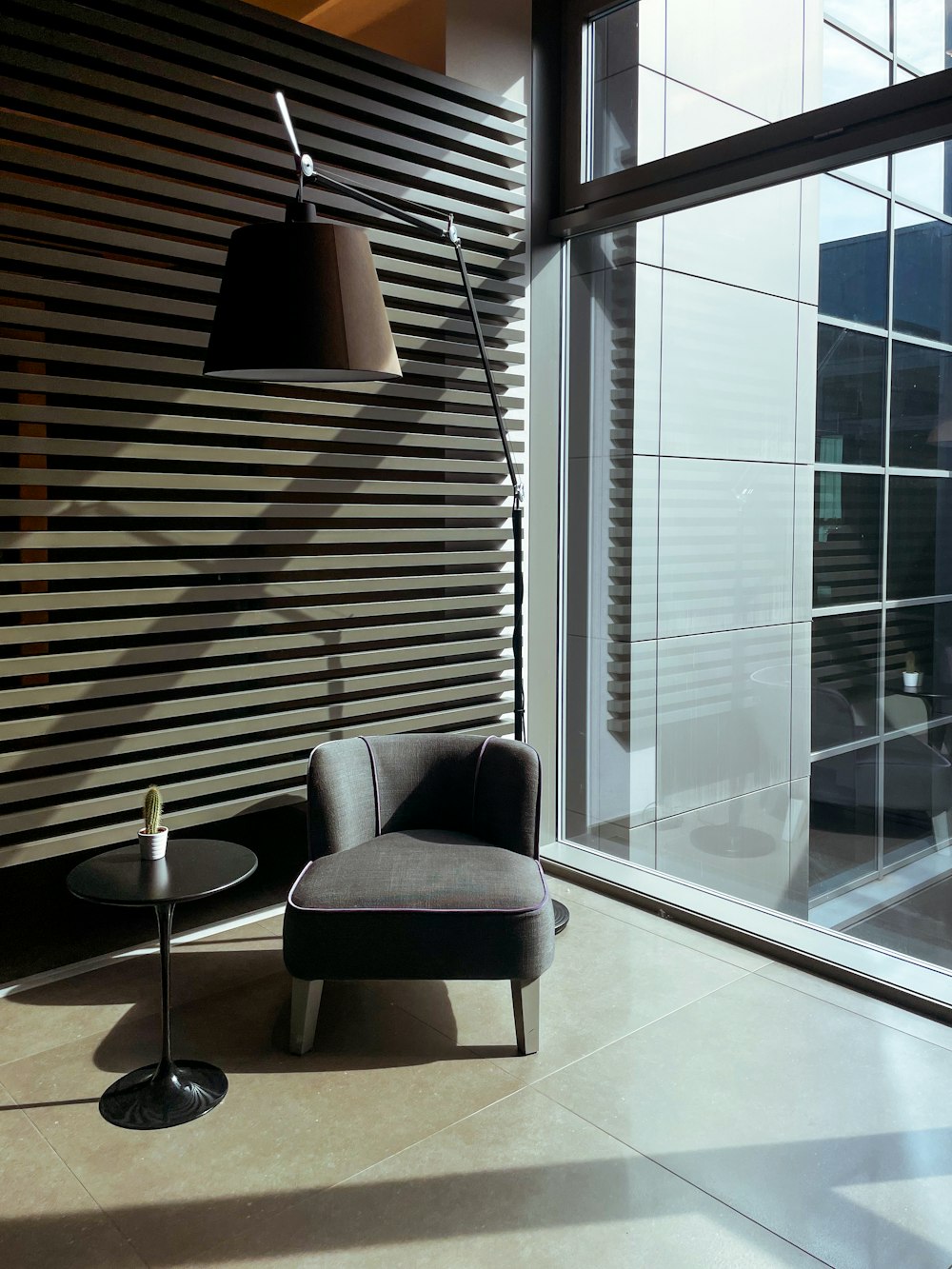 gray sofa chair near glass window
