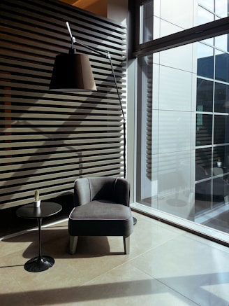 gray sofa chair near glass window
