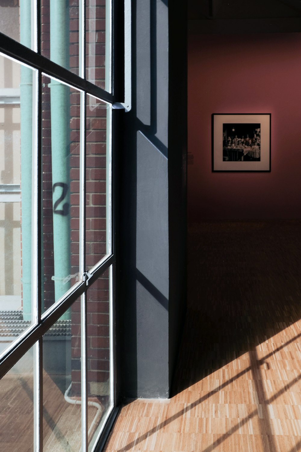 black framed glass door near brown wooden floor