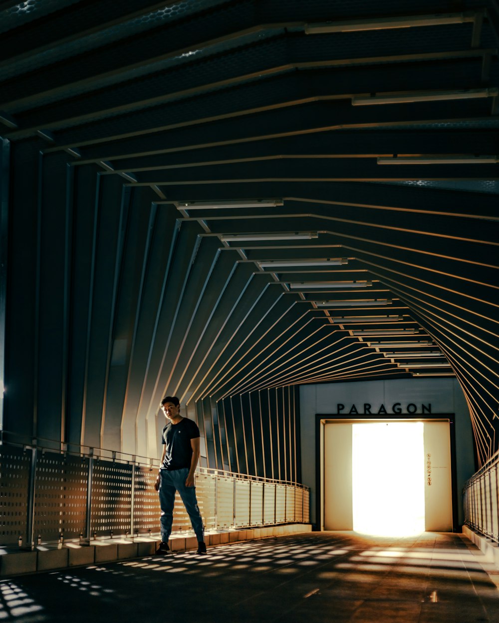 man in blue denim jeans walking on hallway