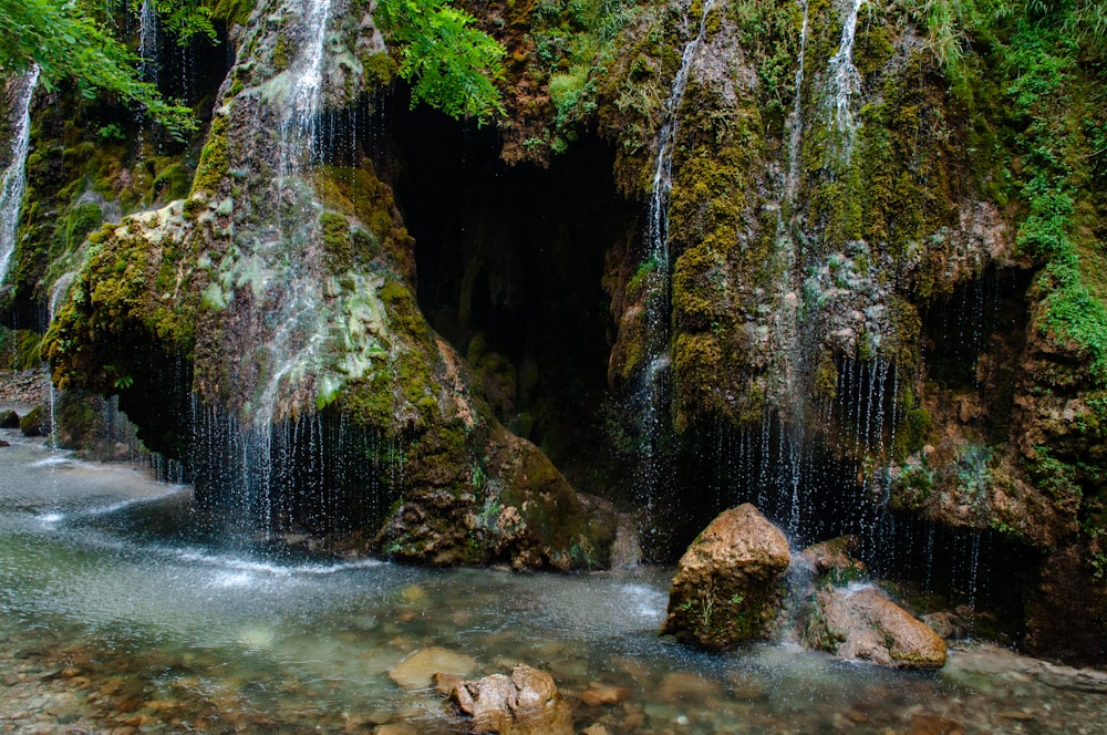 water falls in the middle of the forest