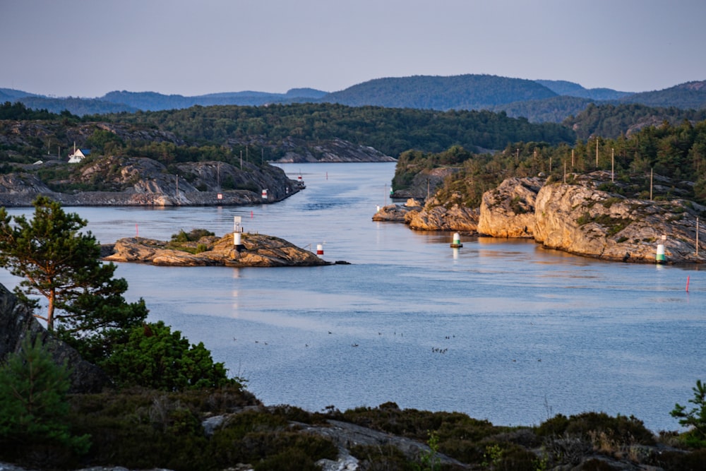 brown rock formation on body of water during daytime