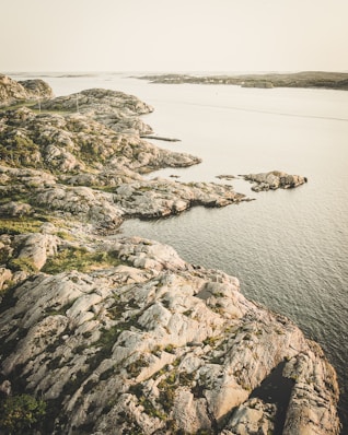 gray rock formation near body of water during daytime