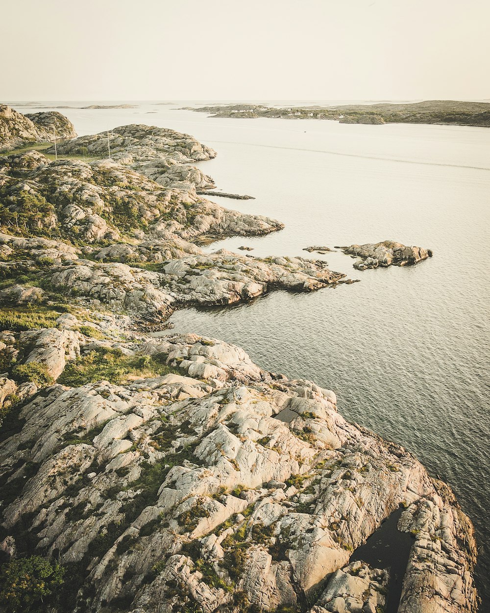 gray rock formation near body of water during daytime