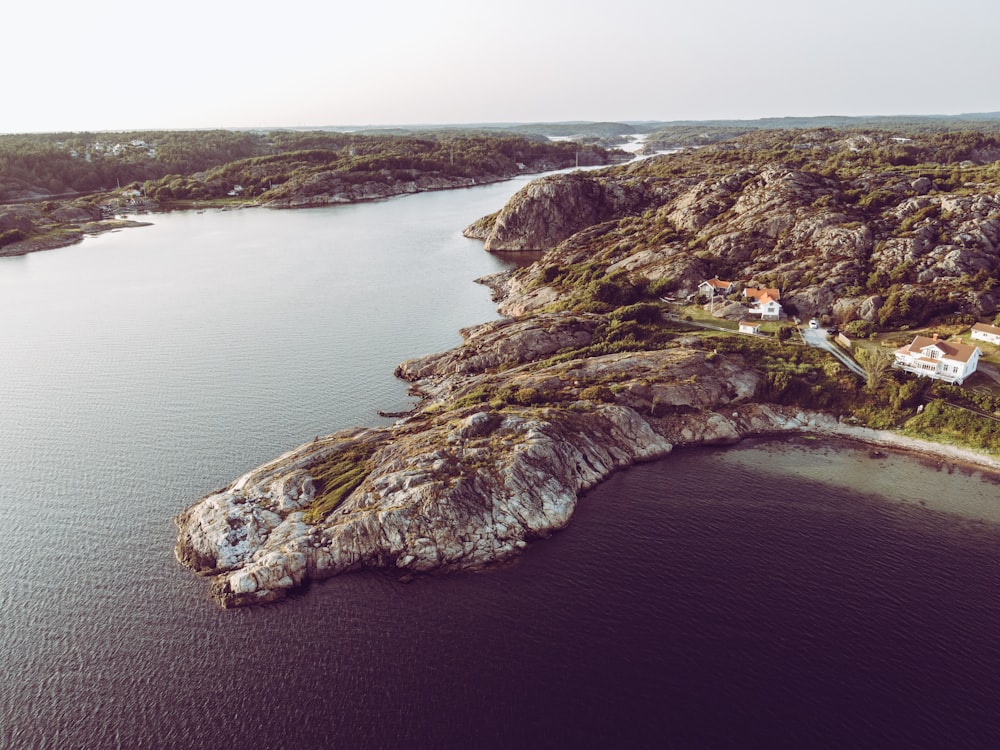 brown and gray rock formation on body of water during daytime