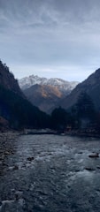 A scenic view of a river with mountains in the background.