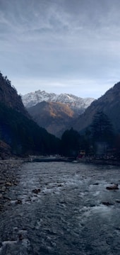 A scenic view of a river with mountains in the background.