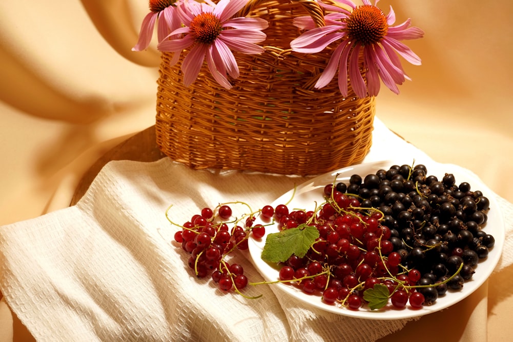 red round fruits on brown woven basket