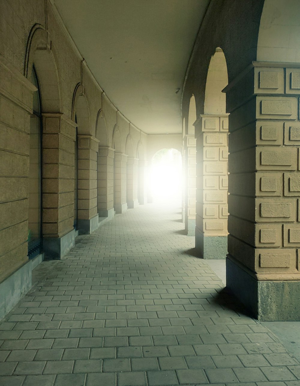 gray and brown brick hallway