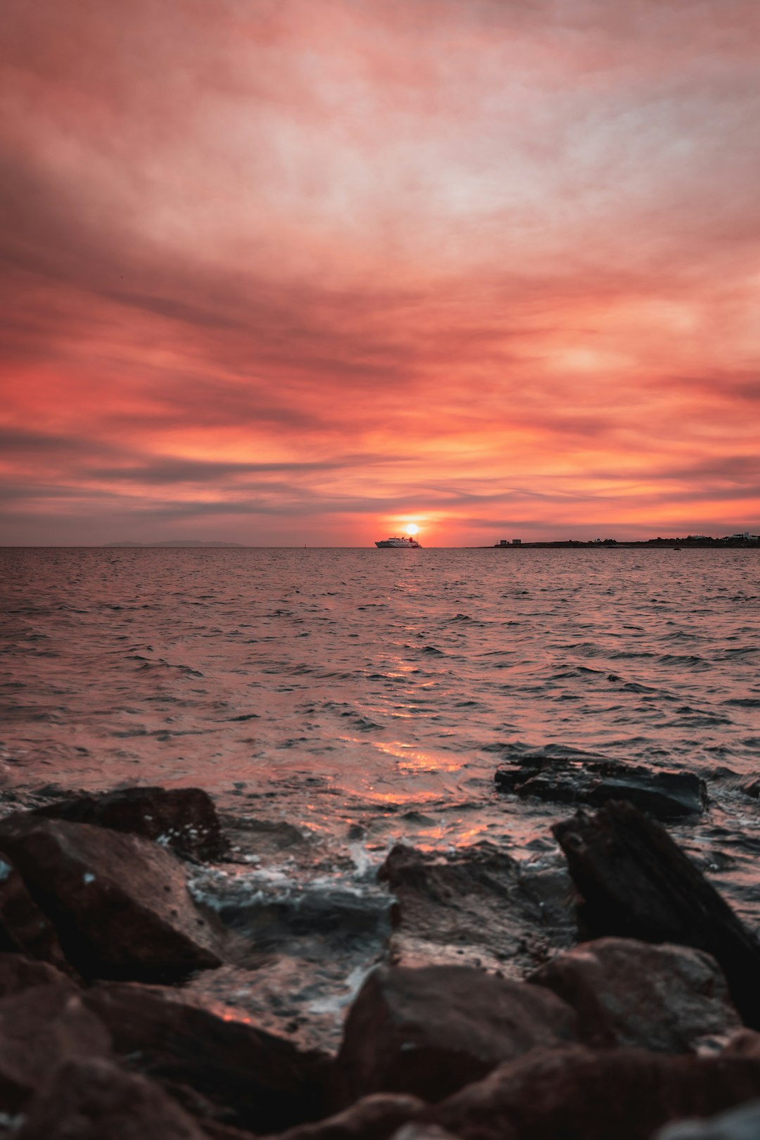 ocean waves crashing on rocks during sunset