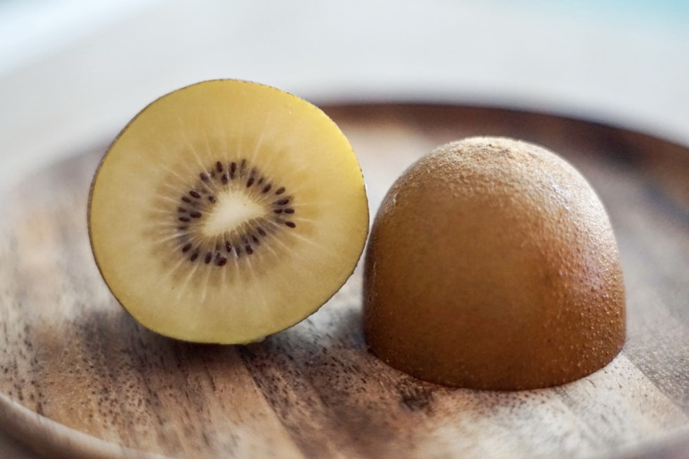 2 yellow round fruits on white ceramic plate