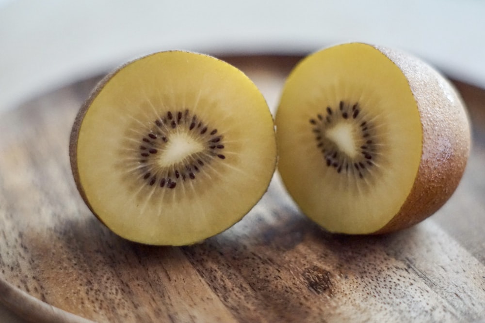 sliced yellow fruit on brown wooden table