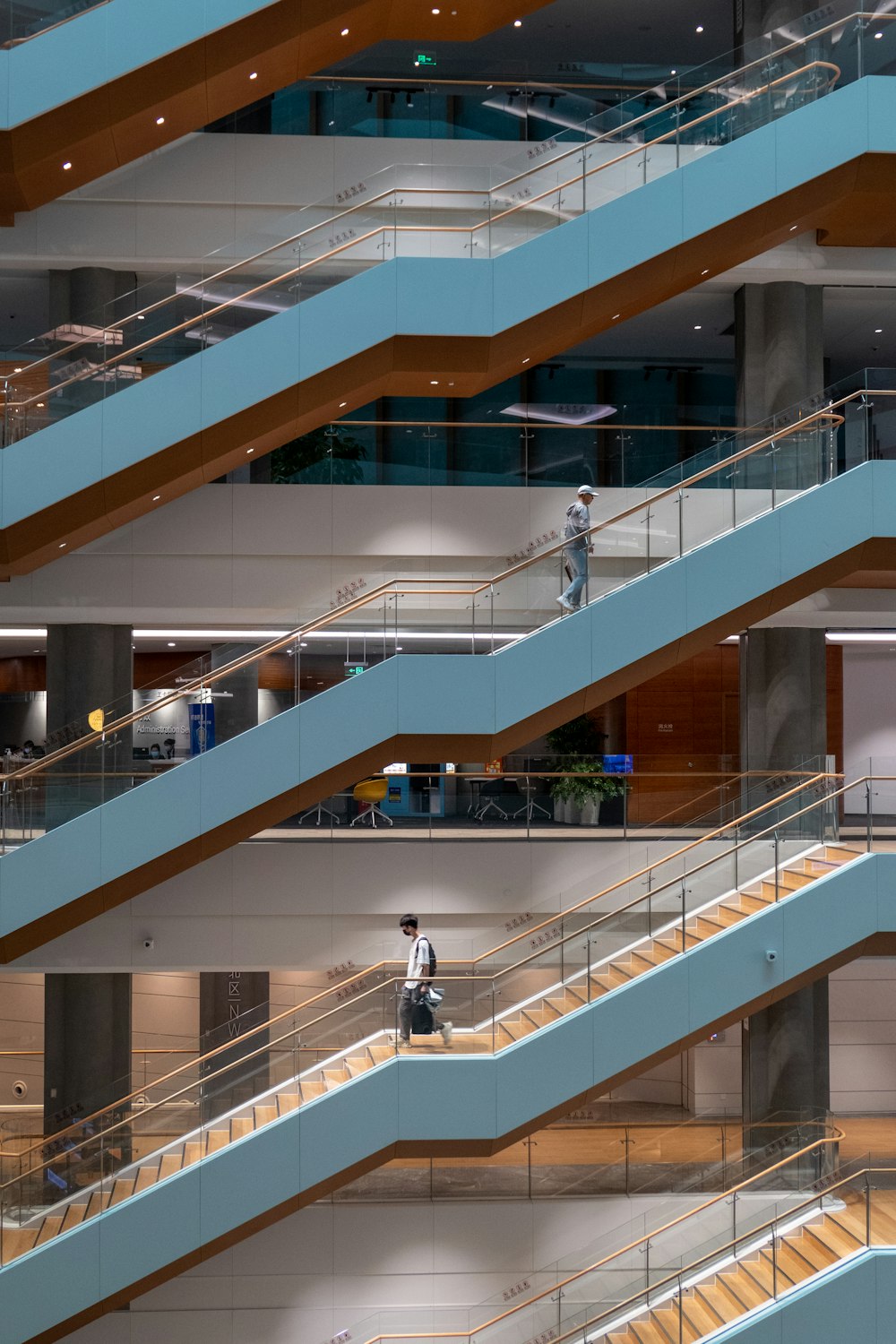 man in white shirt and black pants walking on white staircase