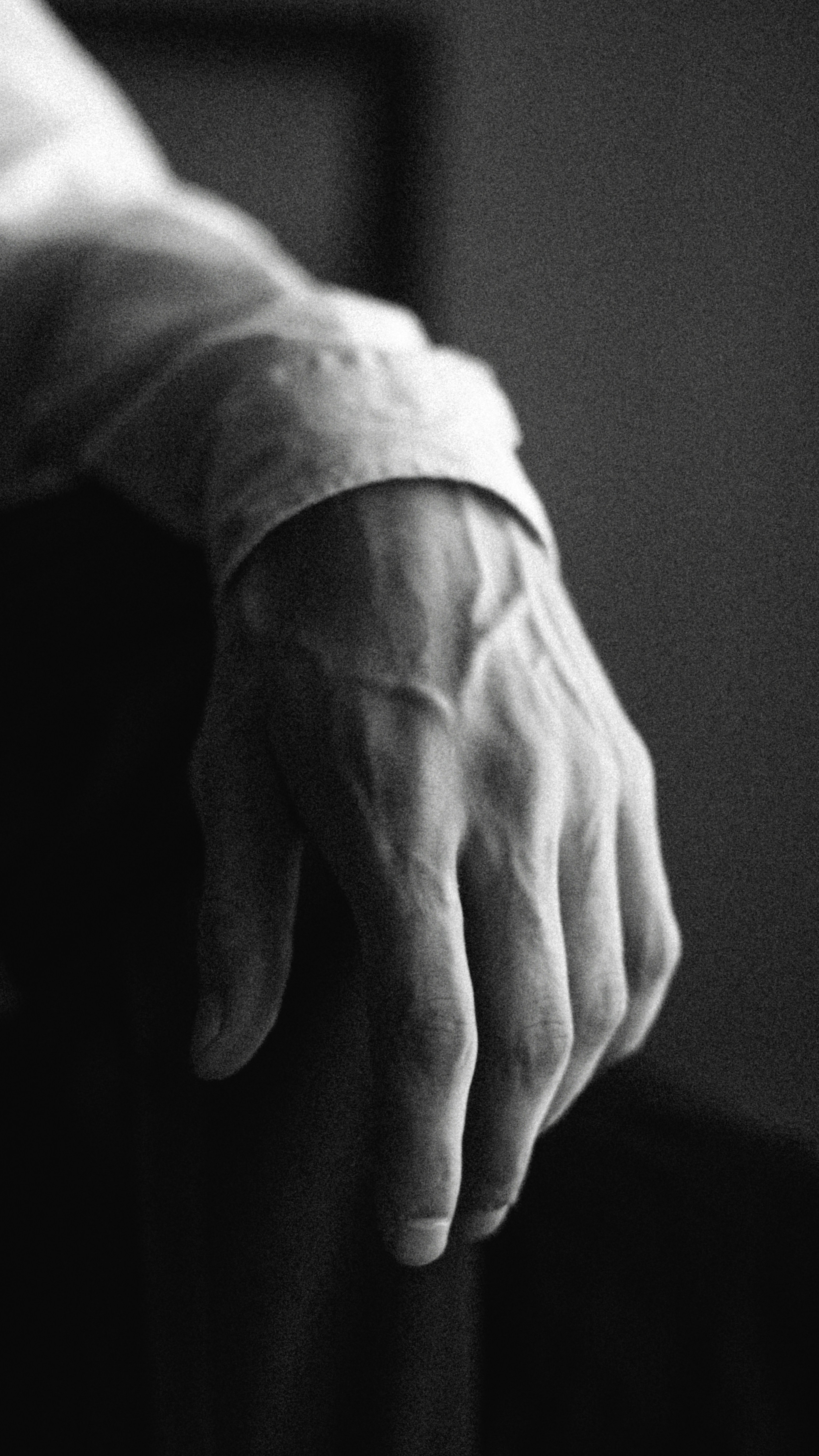 grayscale photo of person holding hands