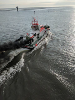 red and white boat on sea during daytime