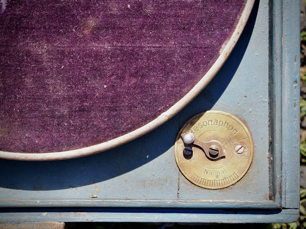 brass round door knob on purple textile