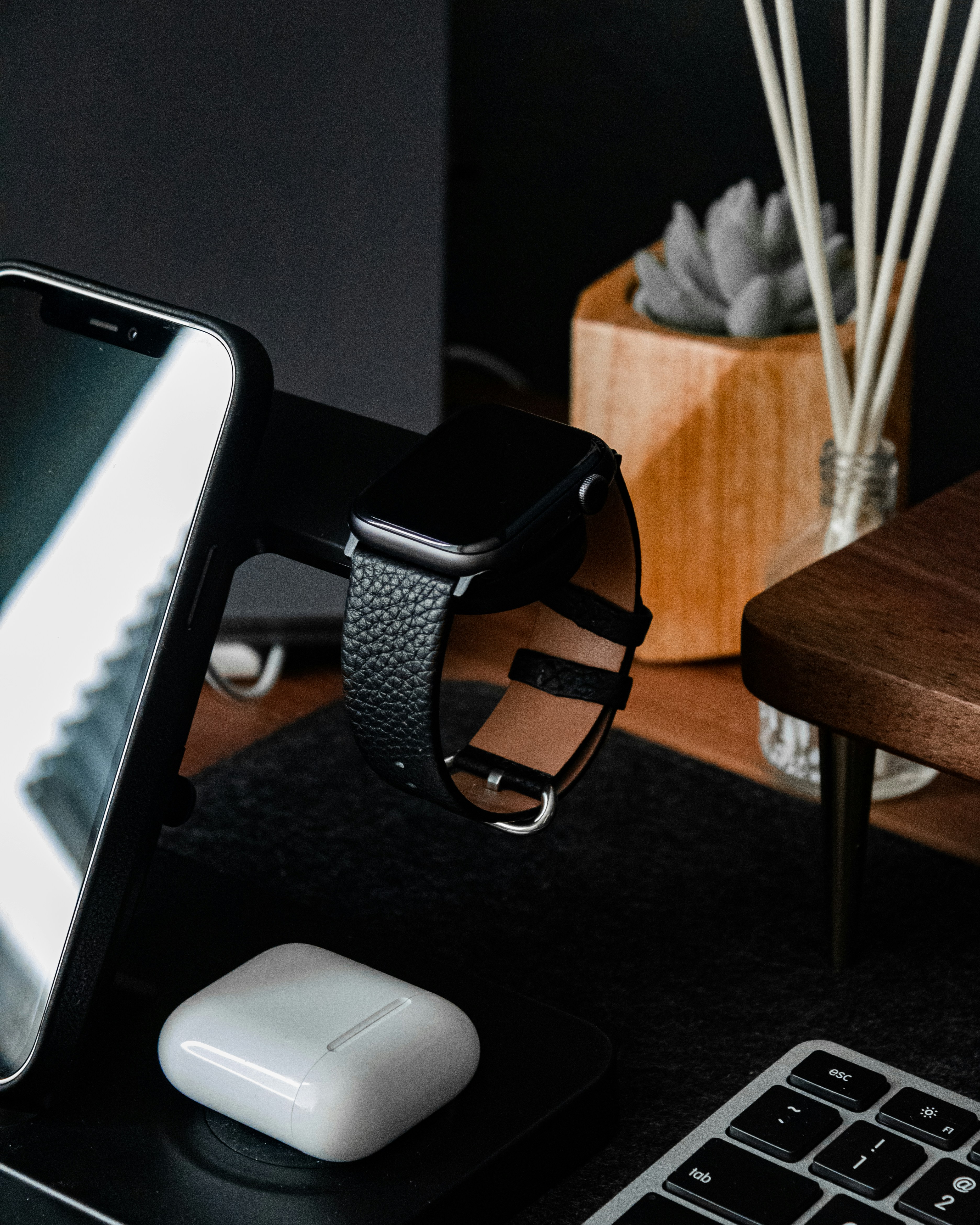 black and silver watch on black wooden table