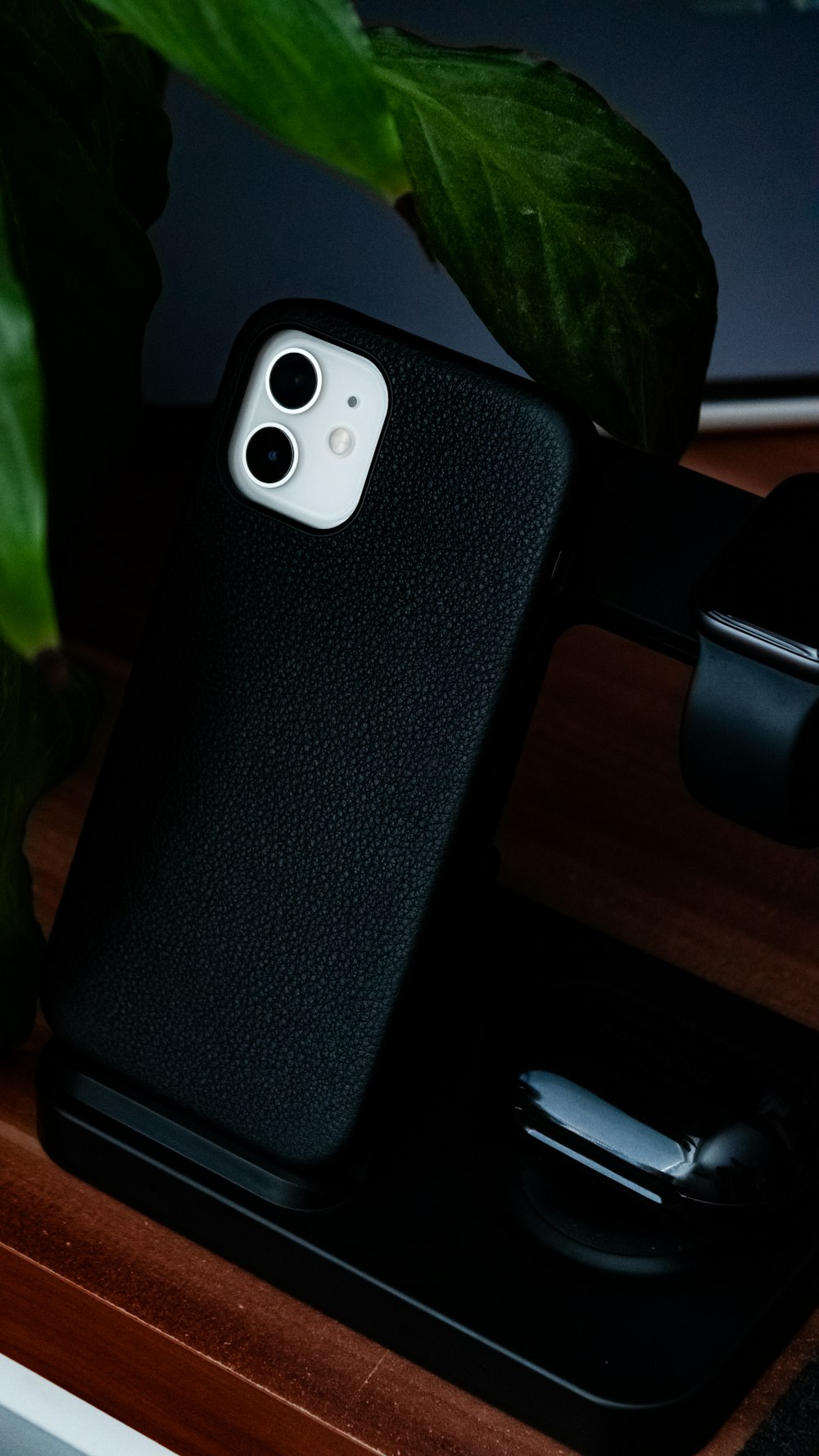 black smartphone on brown wooden table